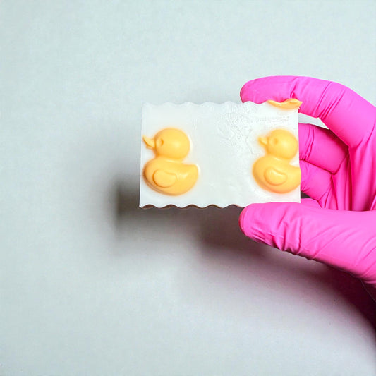White shea butter soap with yellow duck decorations, baby powder scented