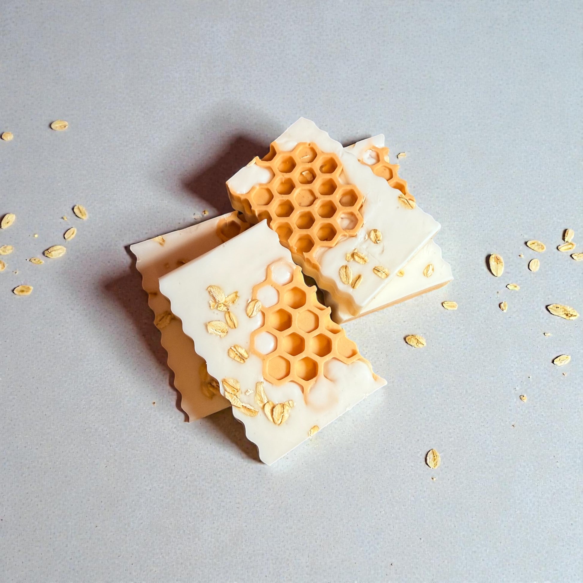 Rectangle shea butter soap with oatmeal, milk, and honey scent, decorated with orange honeycombs and oats