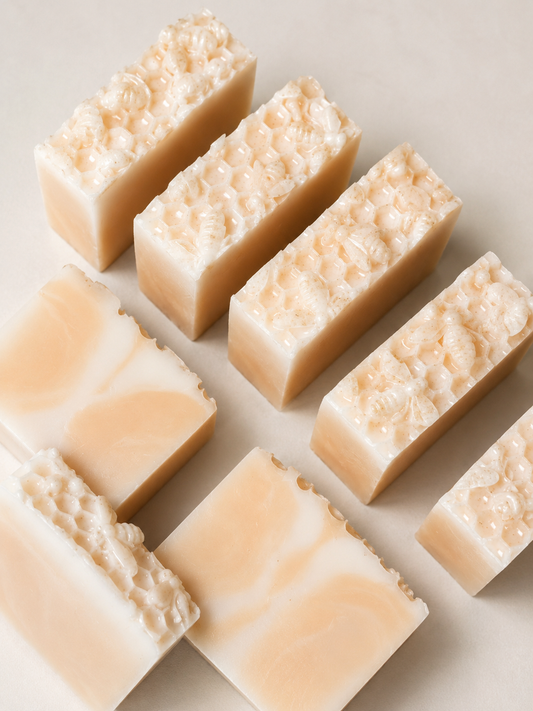 Multiple rectangular soap bars with a textured surface on a light background