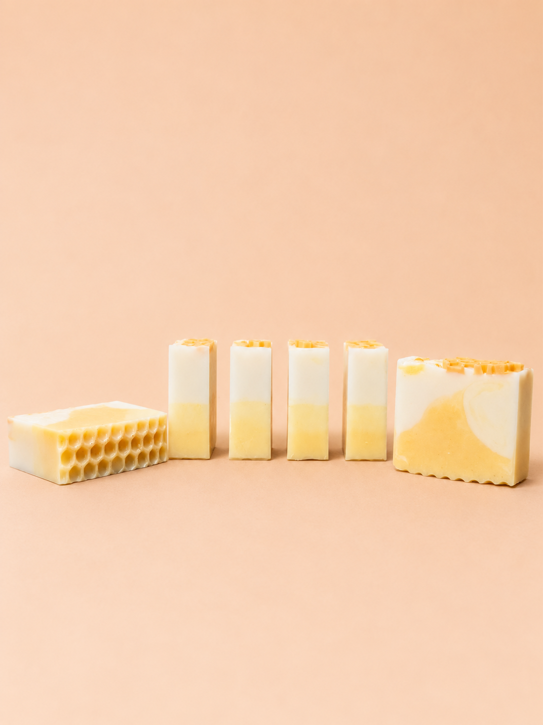 Set of soap bars with a honeycomb design on a beige background