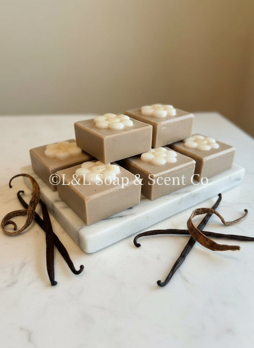 Brown square shape lavender vanilla essential oil Shea butter soaps with white flower in middle.